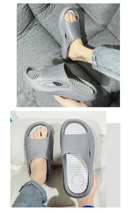 Macro detail of ergonomic grey sports slides featuring a thick sole and ribbed footbed