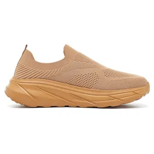 Side profile of breathable tan fly-knit slip-on sneaker with thick cushioned sole.