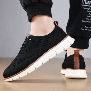 Close-up detail of breathable black mesh sneakers with brown leather accents and white sole.