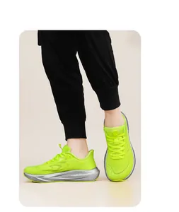 Detailed view of neon green flyknit running shoes with silver carbon plate cushioning soles