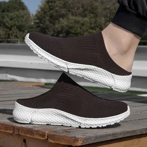Macro detail of dark brown fly-knit slip-on sneakers featuring white textured soles