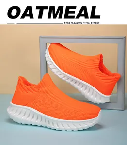 Vibrant orange fly-knit slip-on sneakers with textured white soles for daily sports.