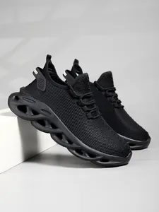 Detailed view of black breathable mesh running shoes with unique wavy sole design