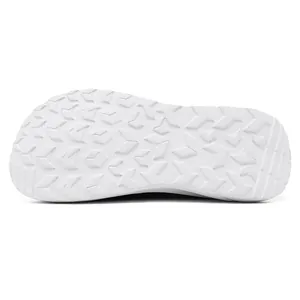 Detailed view of the anti-slip white rubber outsole of wide-toe athletic shoes.