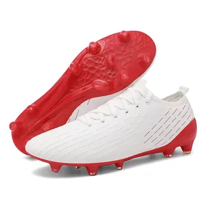 Professional white and red low-top soccer shoes for artificial grass training