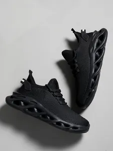 Macro view of black mesh running shoes with hollowed-out cushioning sole on grey background