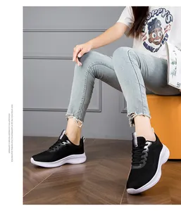 Close-up of black breathable fly-knit running shoes worn with casual jeans