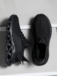Men's black mesh running sneakers featuring lightweight cushioned hollow sole detail