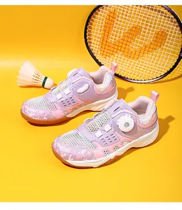 Close-up of children's badminton shoes with rotary buckle closure and breathable mesh