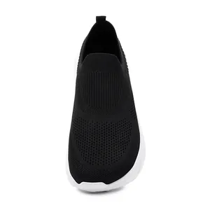 Detail view of black breathable flyknit slip-on sports shoes for men with white sole