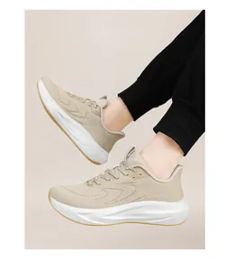 Breathable beige flyknit running shoes featuring a wide toe box and cushioned sole on feet