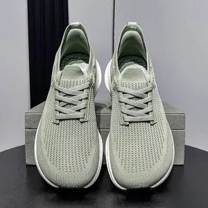 Sage green fly-knit men's running shoes with wide toe box and cushioned sole.