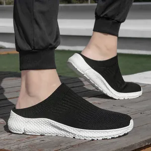Detail view of men's black knit mesh slip-on casual shoes with white textured sole