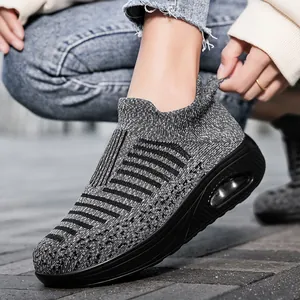 Women's breathable grey knit sneakers with air cushion sole for casual walking comfort.