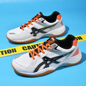 Professional grade badminton shoes with carbon plate and wide last in white and orange