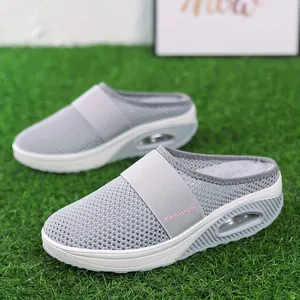 Close-up of grey breathable mesh slip-on mules with comfortable air cushion sole.