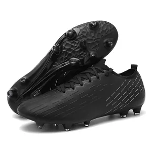 Professional black low-top soccer cleats for men on artificial turf training