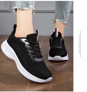 Detail of breathable fly-knit women's sneakers with cushioned white sole