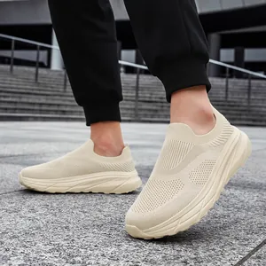 Detailed view of breathable beige slip-on mesh sneakers featuring a comfortable wide toe