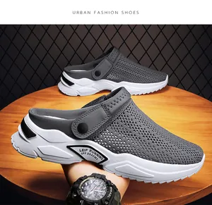 Dettaglio di sabot in mesh grigio traspirante da uomo con design a punta chiusa su tavolo in legno.