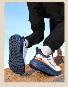 Action shot showing durable lightweight men's safety shoes with thick EVA sole on rocks