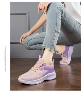 Close-up detail of lightweight pink and purple breathable mesh running shoes on model