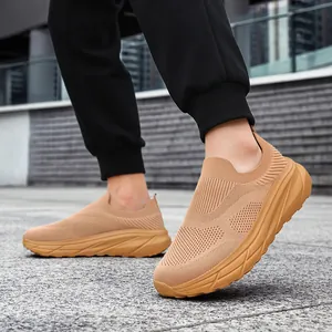 Detail view of breathable khaki slip-on mesh sneakers for men in an urban setting