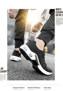 Detailed close-up of men's black mesh sports sneakers with white air cushion thick sole.