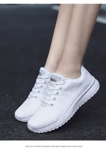 Detail view of white breathable fly-knit sneakers for women with lace-up design
