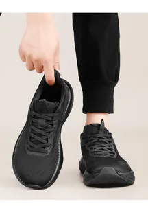 Detail view of breathable black knit running shoes with wide toe box design