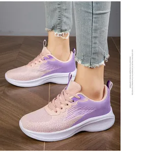 Detail view of purple and pink breathable fly-knit running sneakers with lightweight EVA sole
