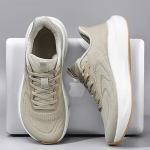 Close-up showing breathable knit texture and cushioned sole of beige running shoes.