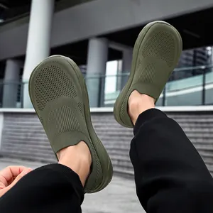 Macro view of olive green breathable wide-toe knit slip-on leisure sneakers for men