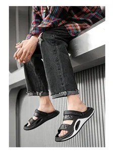 Side view of black men's dual-wear sports sandals with white accents worn by a model