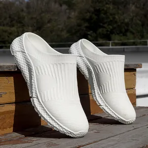 Detail of white flyknit mesh sneakers with breathable texture and soft sole.