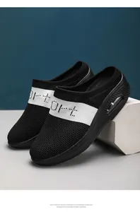Close-up of black fly-knit platform mules with air cushion sole and white band