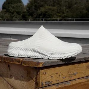 Detail view of white fly-knit upper and textured sole on lightweight slip-on shoes