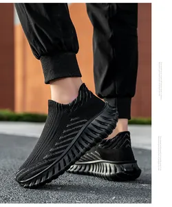 Detail view of breathable black knit slip-on sneakers with durable textured rubber sole.