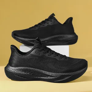 Side view of breathable black fly-knit running shoes with cushioned thick soles on pedestal