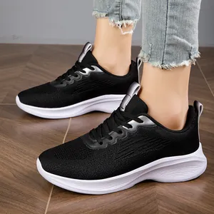 Breathable fly-knit women's sneakers in black with thick white soles for running
