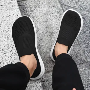 Top-down view of breathable black flyknit slip-on sneakers with wide toe box for men