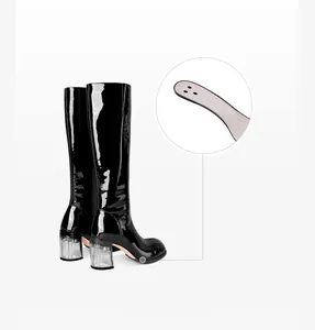 Close-up detail of the sole construction on black patent leather knee-high boots