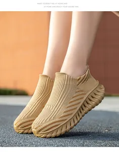 Close-up of tan breathable fly-woven slip-on sports sneakers with thick wavy soles
