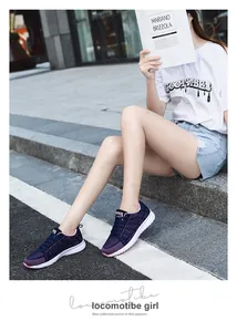 Close-up view of lightweight breathable navy blue knit sneakers on an Asian model