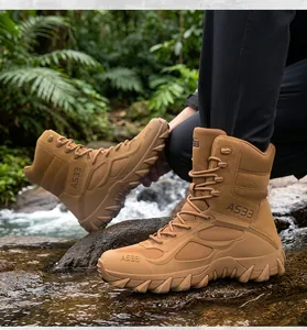 Detail view of men's tan tactical combat boots in an outdoor river environment