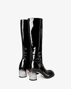 Detailed back view of black patent leather knee-high boots with clear chunky heel.