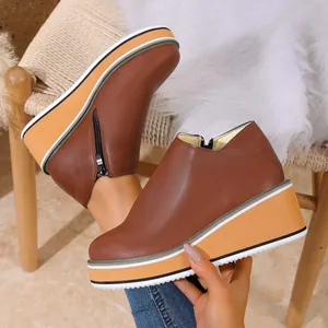 Bottines à plateforme pour femmes en marron avec fermeture éclair latérale et semelle compensée.