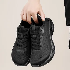Detail showing the black breathable knit upper of carbon plate athletic running shoes