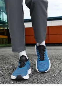 Close-up of blue breathable mesh men's running shoes with wide fit and cushioned sole