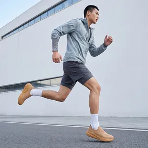 Action shot of men's breathable slip-on running shoes in tan flyknit fabric